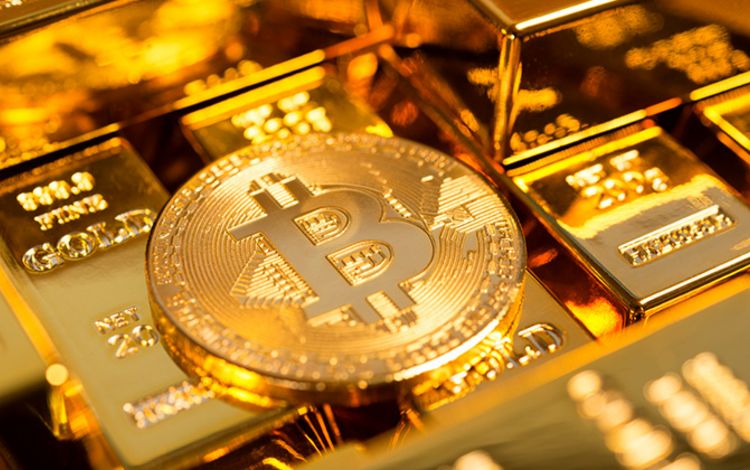 Ein Bitcoin als Münze auf Goldbarren