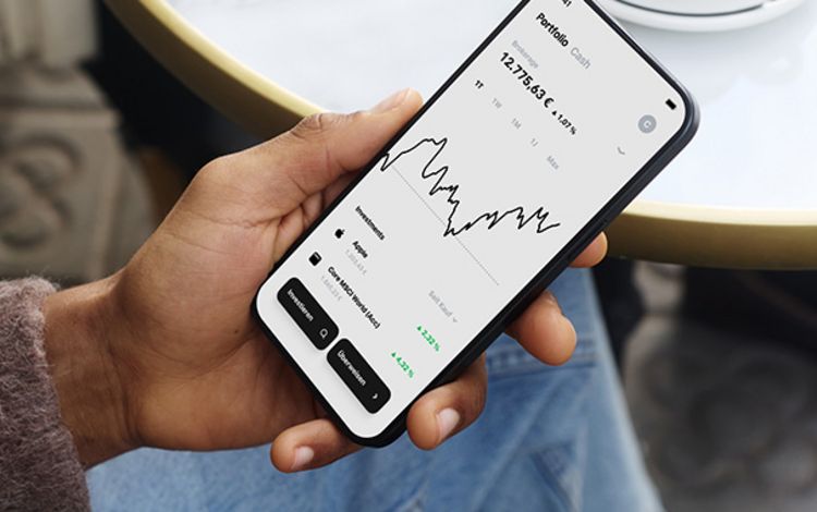 Eine Hand mit Smartphone zeigt die Benutzeroberfläche des Neo-Brokers Trade Republic