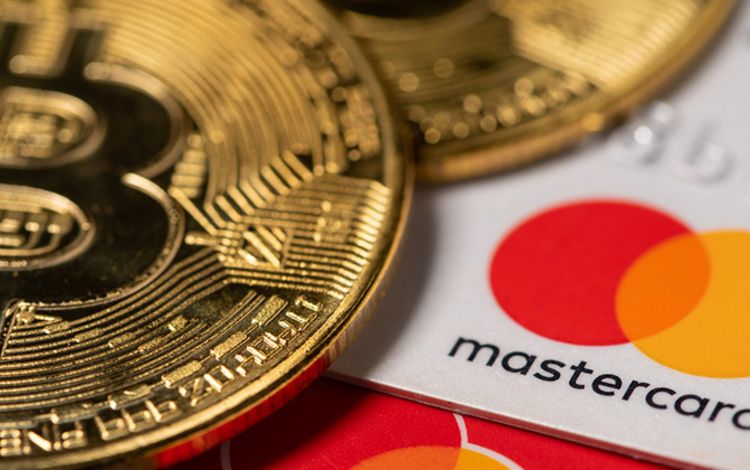 Bitcoin-Münze mit Karte von Mastercard