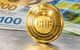 Eine goldfarbene Münze zeigt eine Stablecoin, der mit Schweizer Franken besichert ist