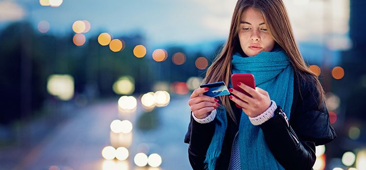 Junge Frau macht eine Zahlung am Smartphone