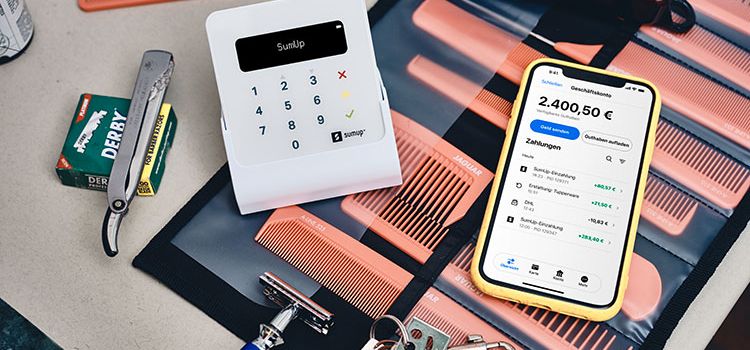Ein kleines Zahlterminal von Sumup neben einem Smartphone, dass die erfassten Zahlungen anzeigt