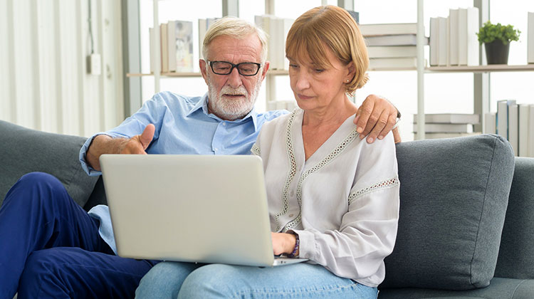 Älteres Paar am Laptop bei einer digitalen Kontoeröffnung