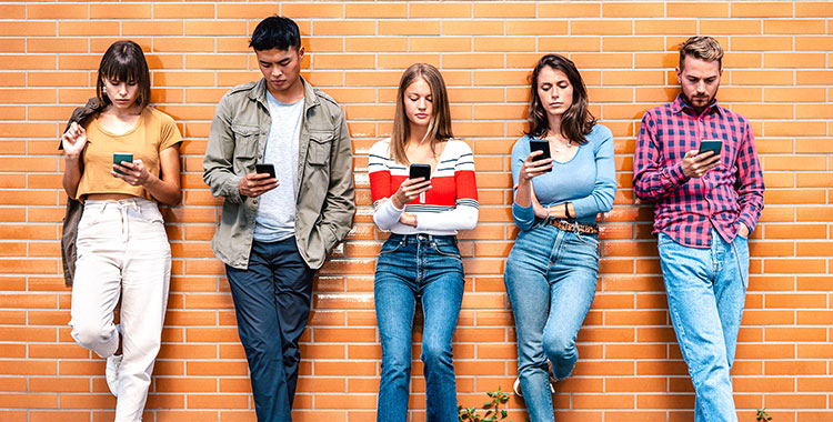Junge Menschen der Generation Z, alle mit ihrem Handy beschäftigt